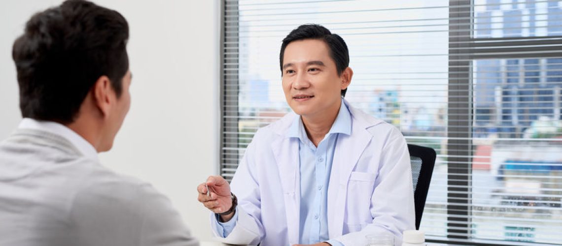Asian doctor consults young patient