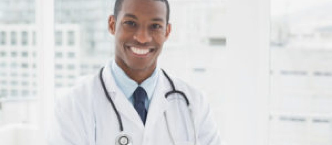 Portrait of a confident smiling male doctor standing in a medical office