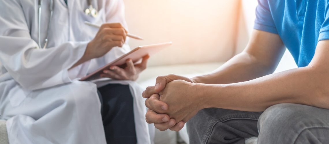 Men's health exam with doctor or psychiatrist working with patient having consultation on diagnostic examination on male disease or mental illness in medical clinic or hospital mental health service