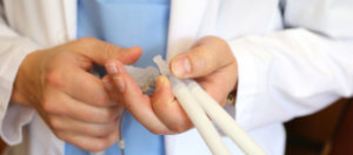 Doctor andrologist holding hydraulic penile prosthesis for falloprosthetics. Penile prosthesis. Urology and Andrology. Health male concept